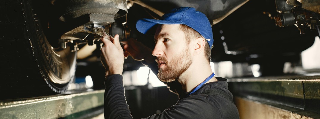 A photo of a person working on a car.