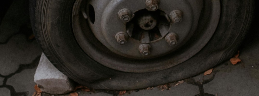 A stock photo of a flat tire on an old car.