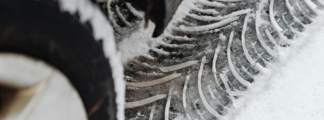 A stock photo of some winter tires making tracks.